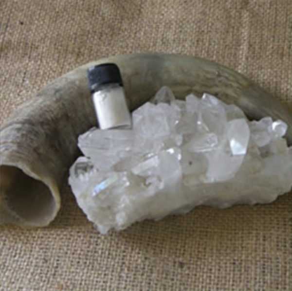 A cowhorn, a hunk of quartz crystals, and a vial of ground quartz.