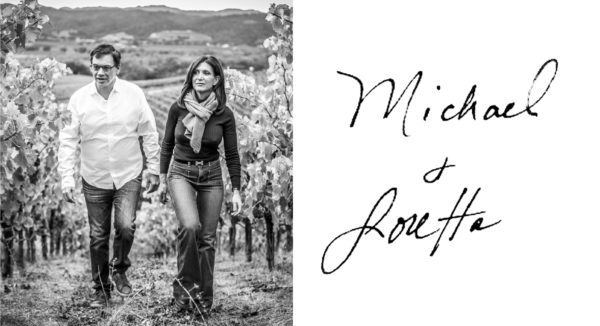 michael and loretta walking in vineyard, plus their signatures
