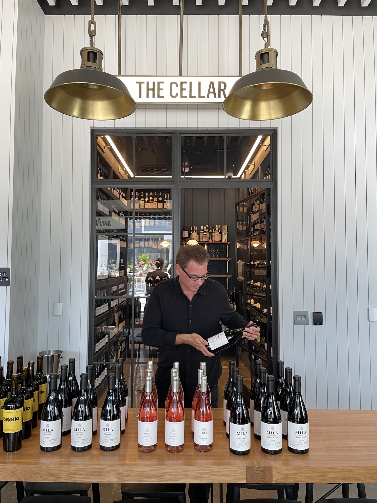 michael at The Cellar with a lineup of bottles
